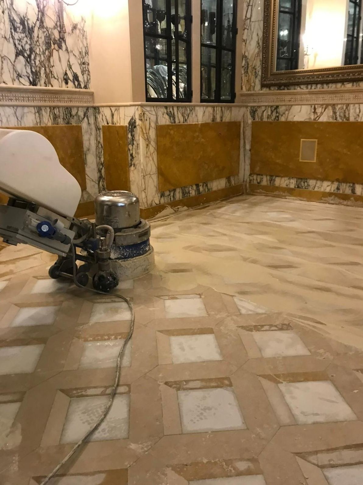 Rotary floor machine restoring a natural stone floor