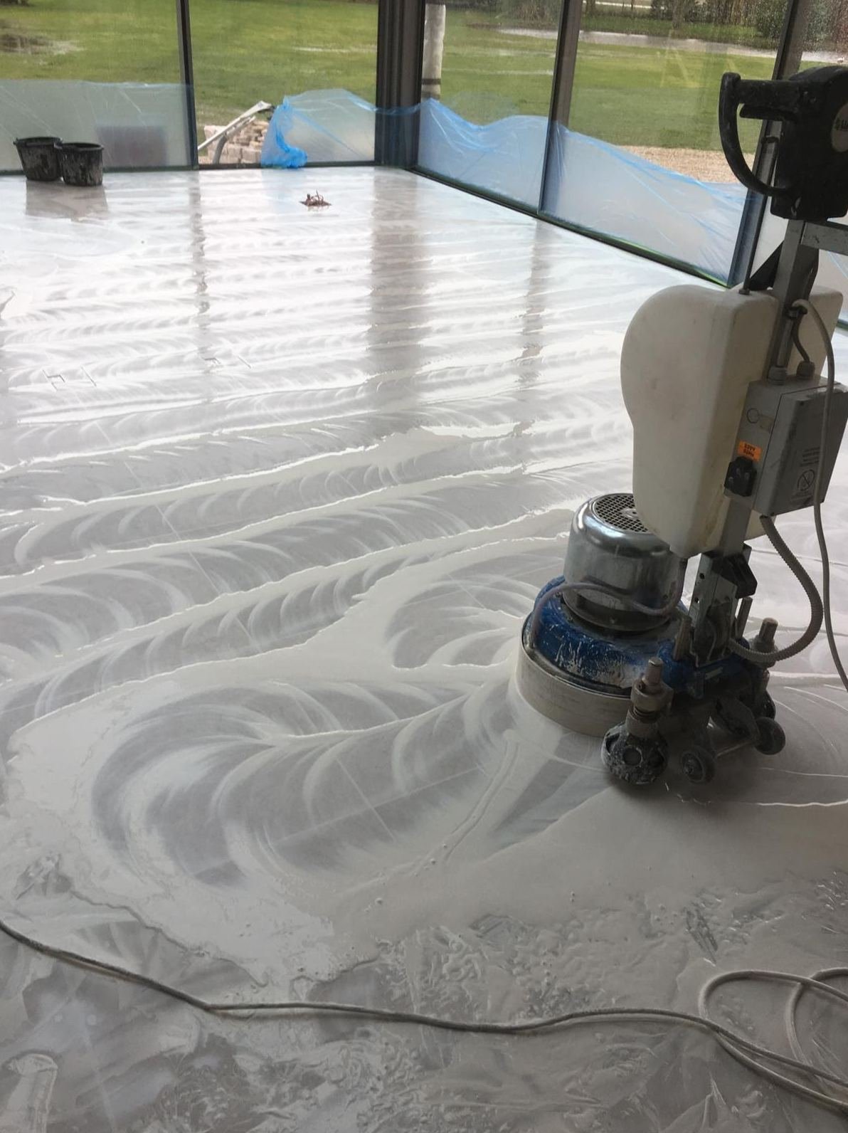 Wet polishing pass on a natural stone floor